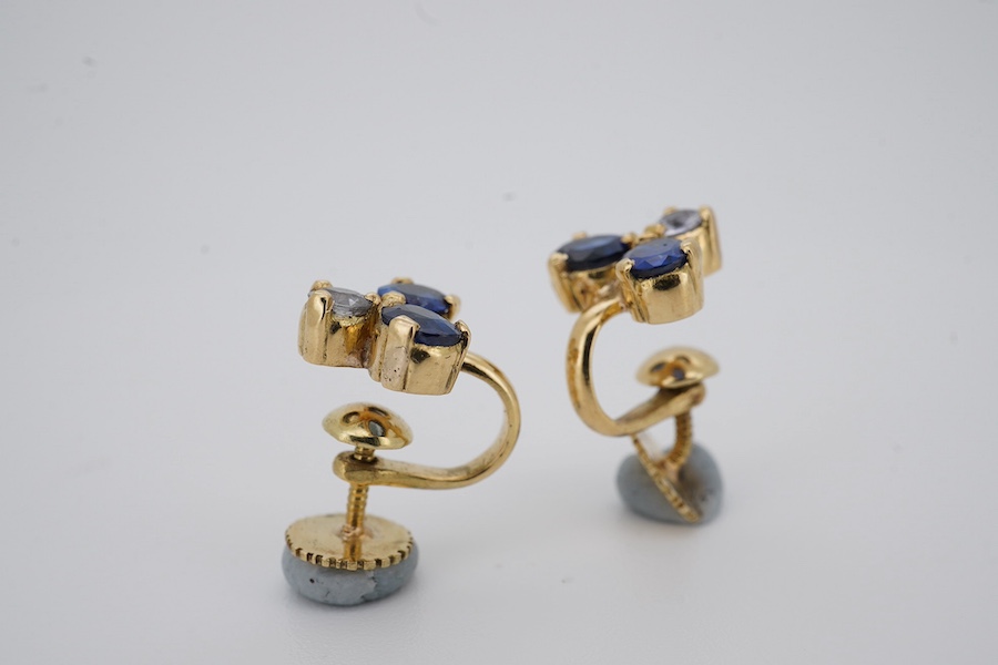 A modern pair of yellow metal and three stone blue and white sapphire cluster set ear clips, approx. 8mm, gross weight 3 grams. Condition - poor to fair